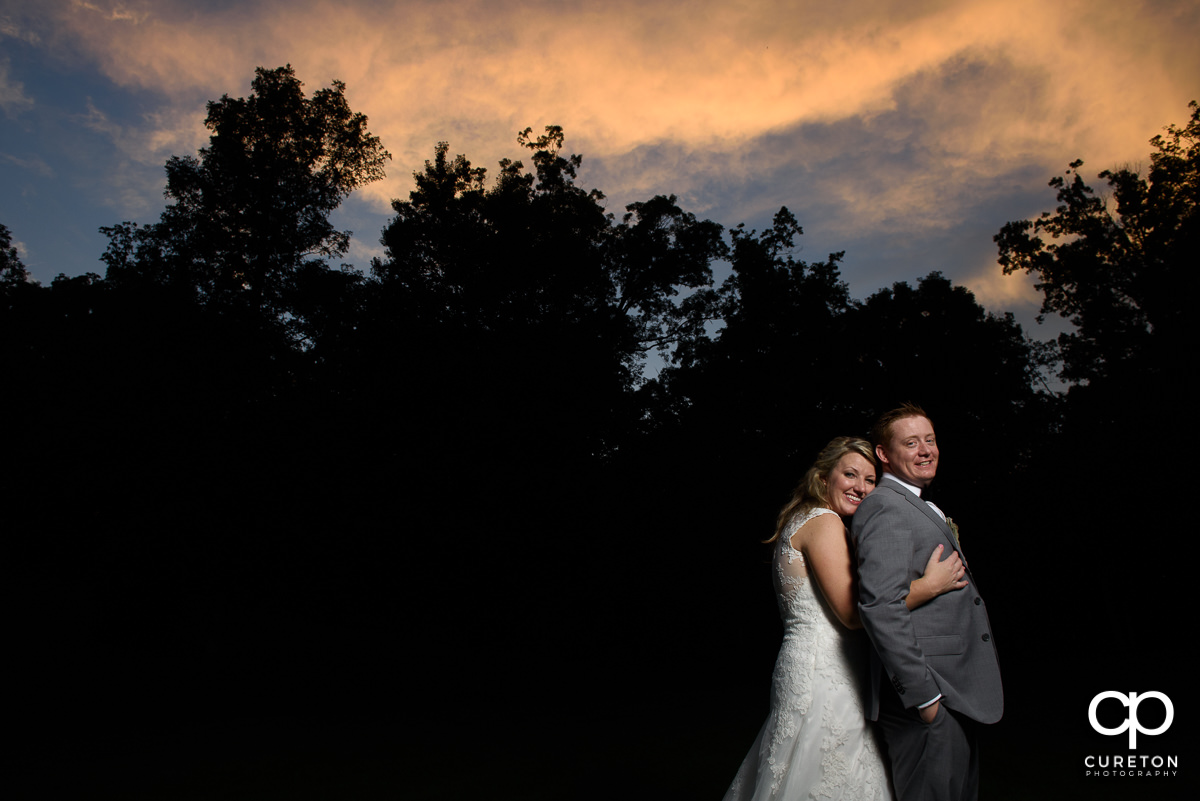Bride and groom at sunset at their wedding reception at The Hollow at Paris Mountain in Greenville,SC.