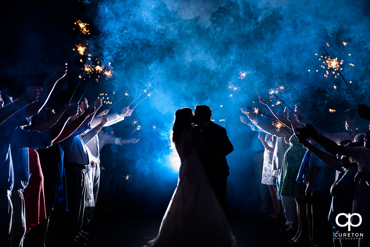 Bride and groom making a grand exit though sparklers at the end of the evening.