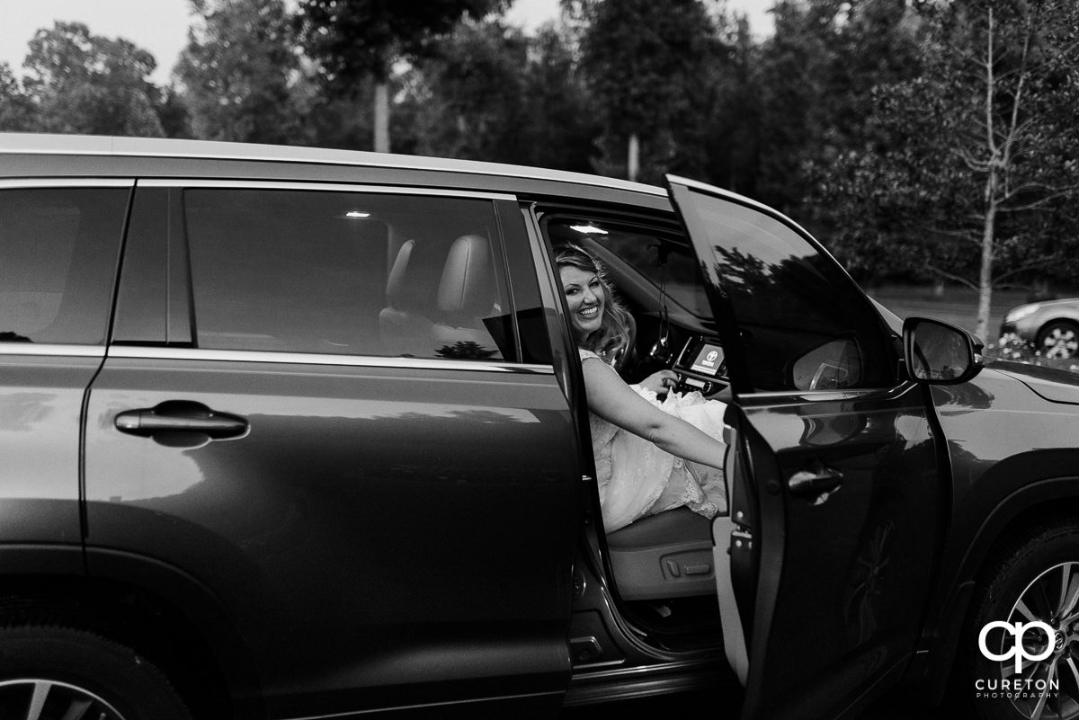 Bride getting in the car after the grand exit.
