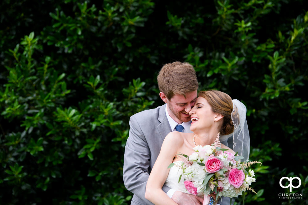 Bride and groom laughing.