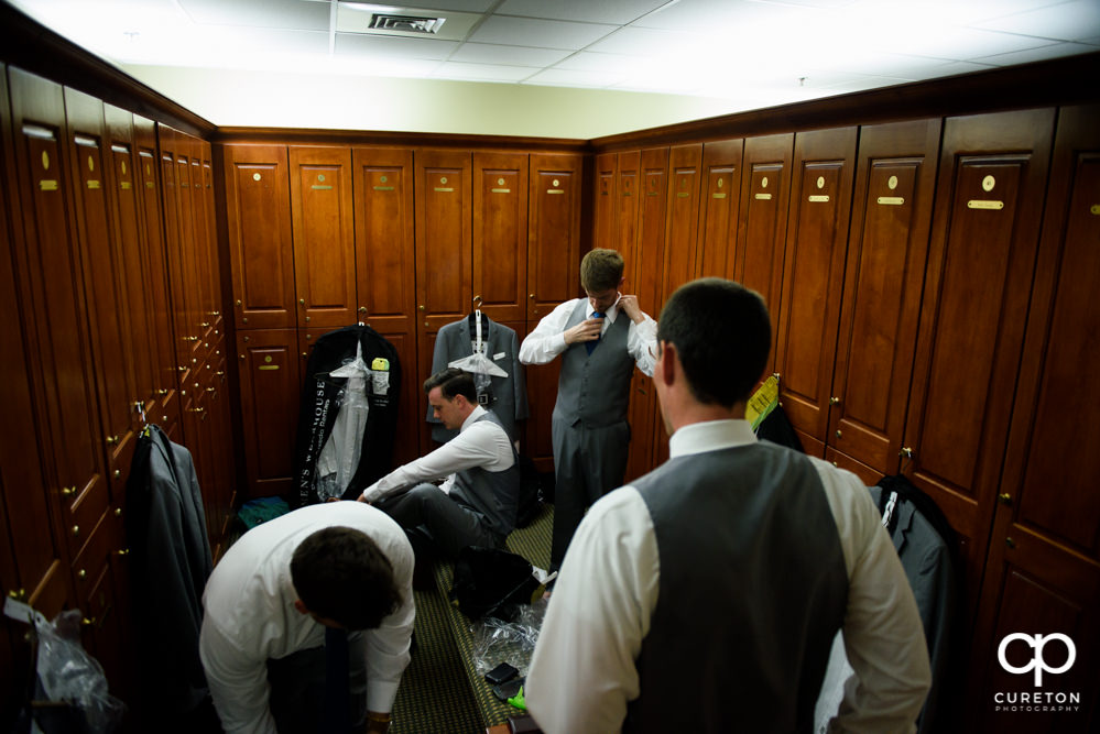 Groom and groomsmen getting ready in the locker room.