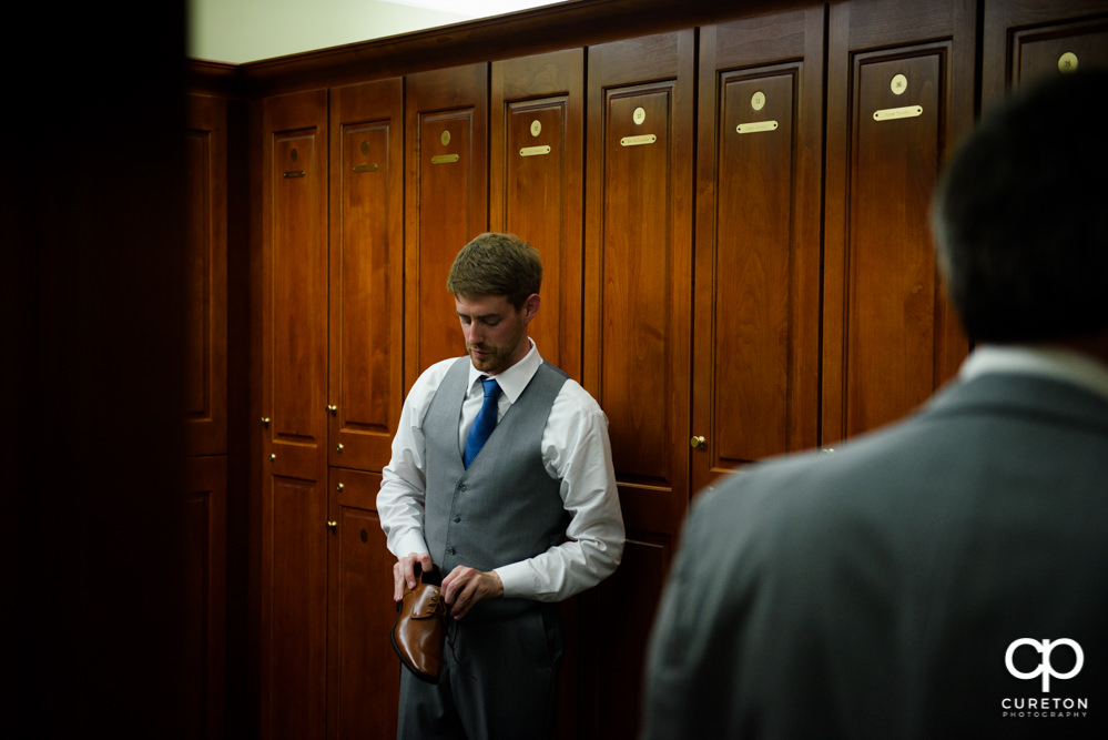 Groom getting dressed before the wedding.