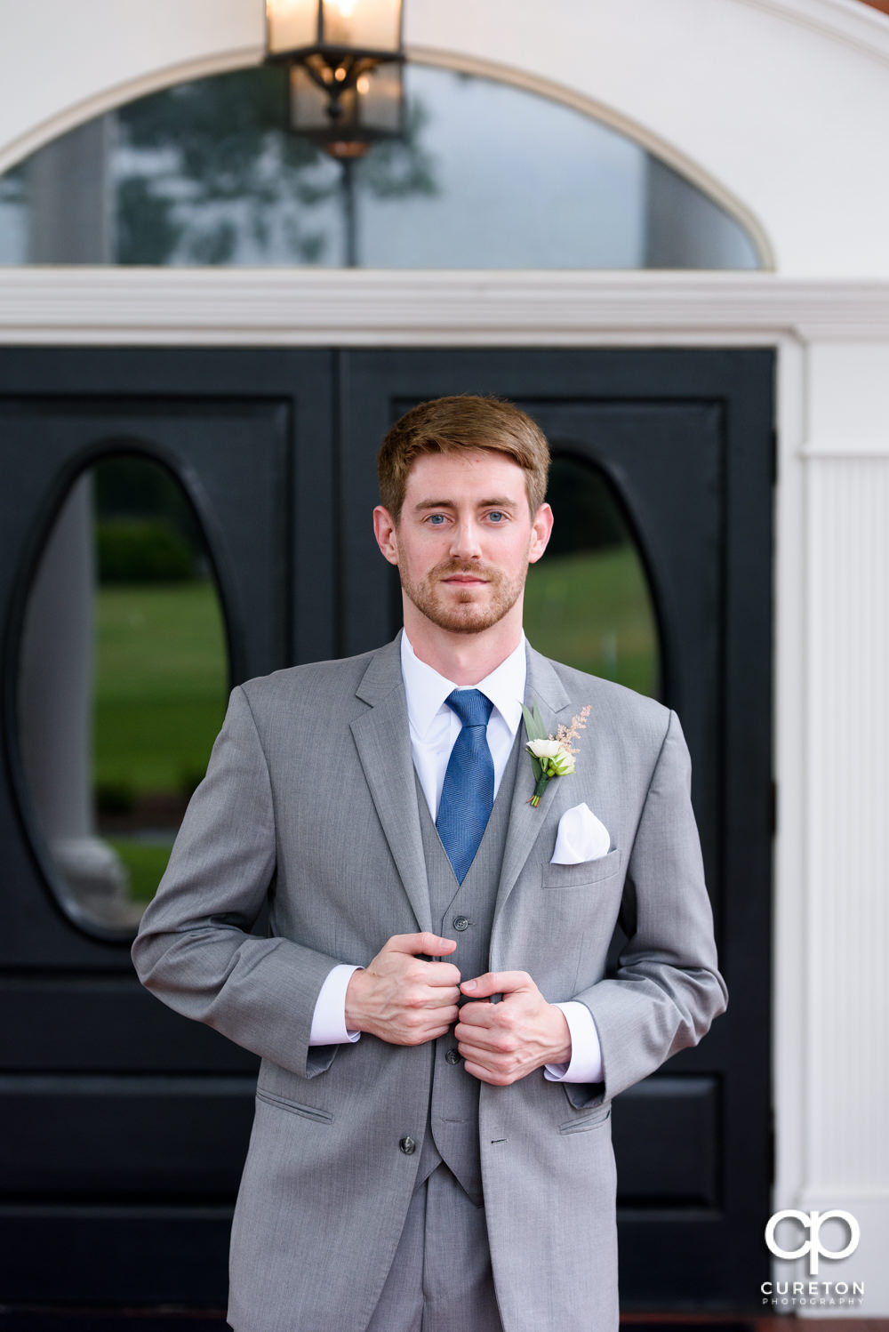 Groom in front of the wedding venue.