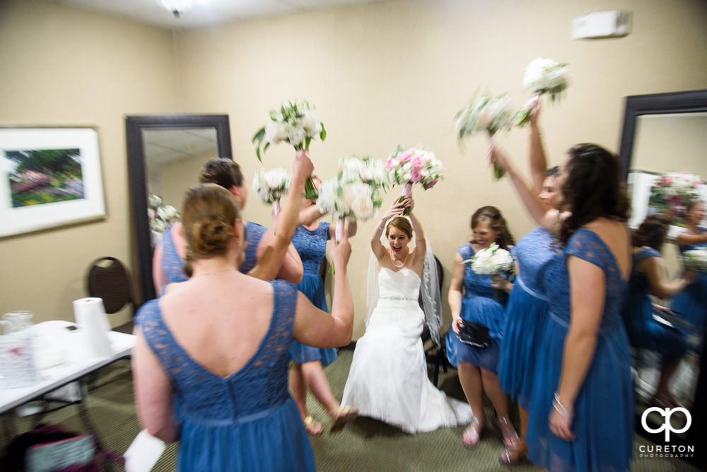 Bride and bridesmaids having fun before the ceremony.