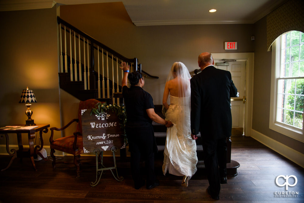 Bride walking up the stairs.