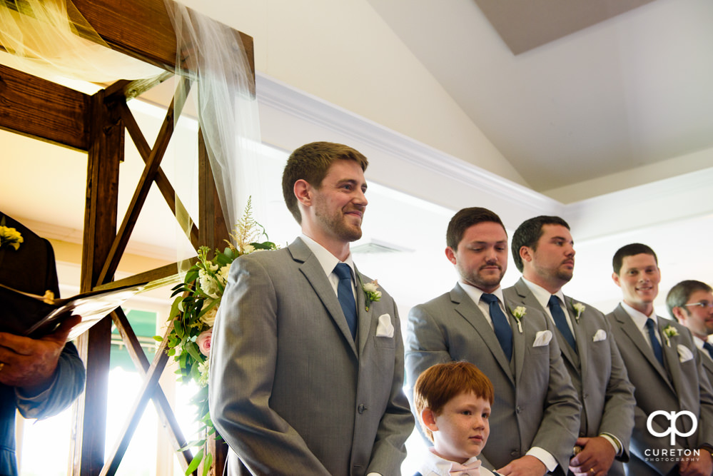 Groom seeing his bride walking down the aisle.