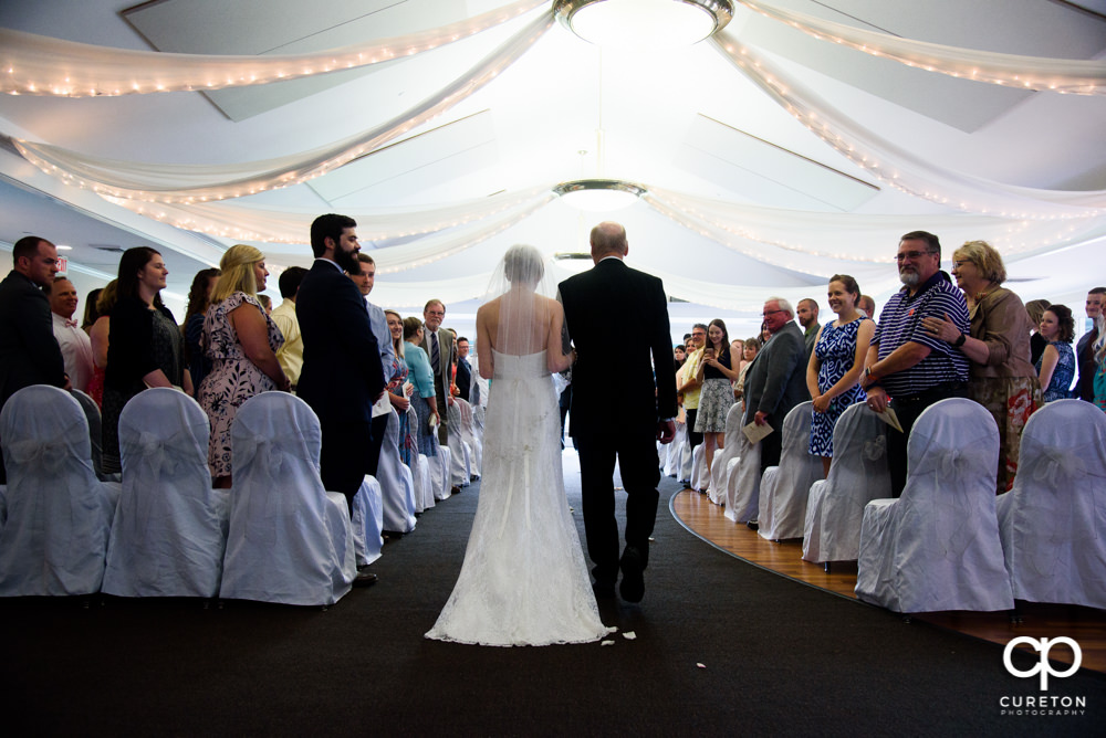 Bride and her father walking down the aisle.