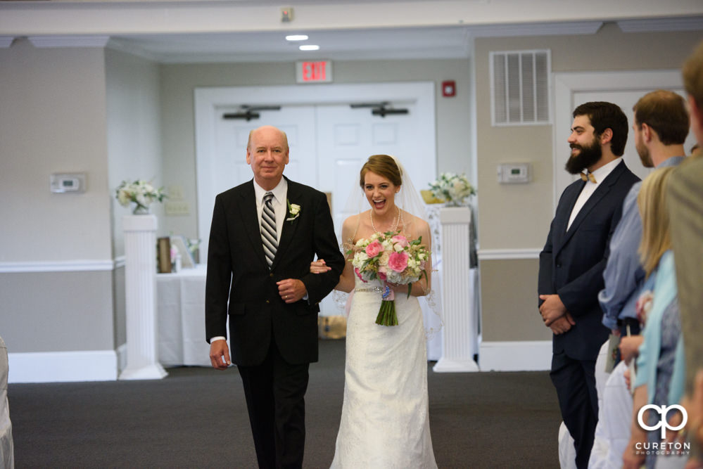 Bride and her father walking down the aisle.