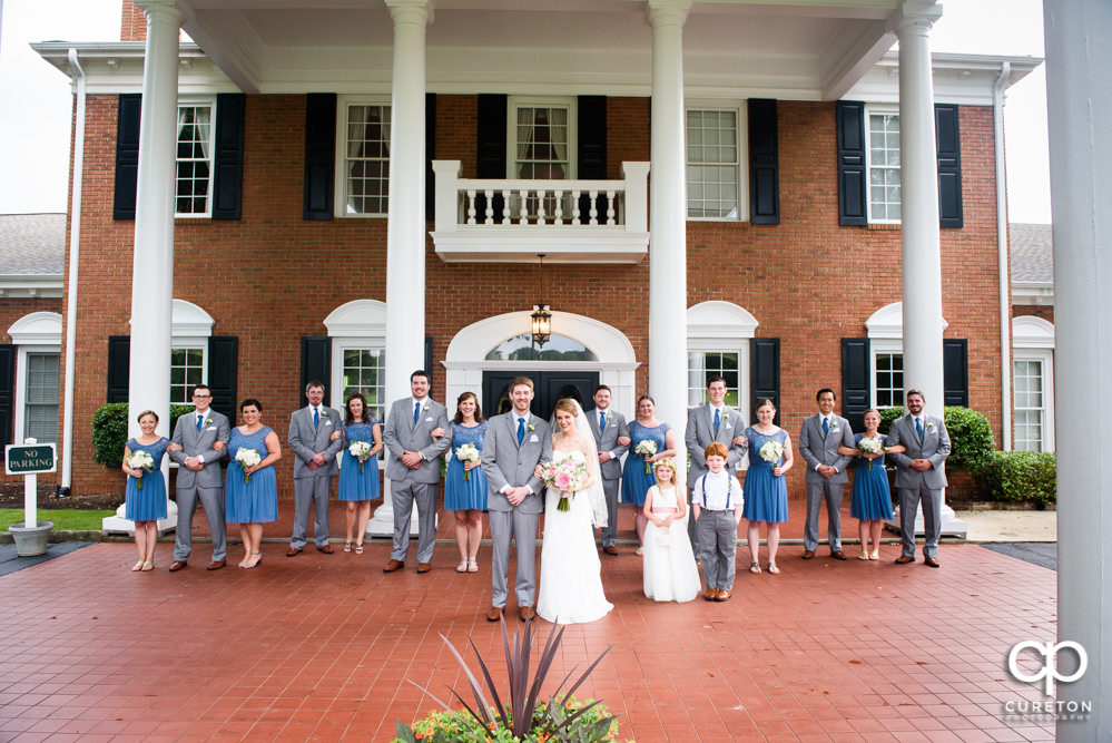 Wedding party in front of Holly Tree Country Club after the wedding ceremony.
