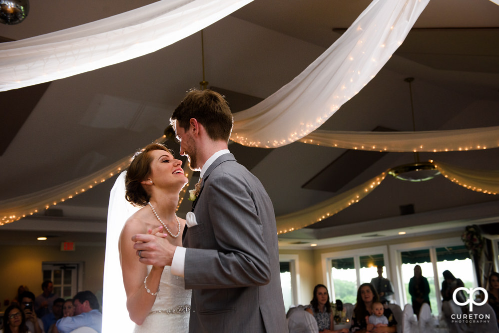 Bride and groom having their first dance at the wedding reception.