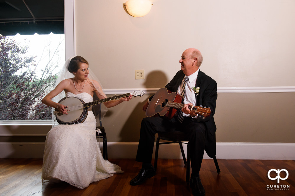 Bride and her father playing guitar and banjo at her wedding reception.