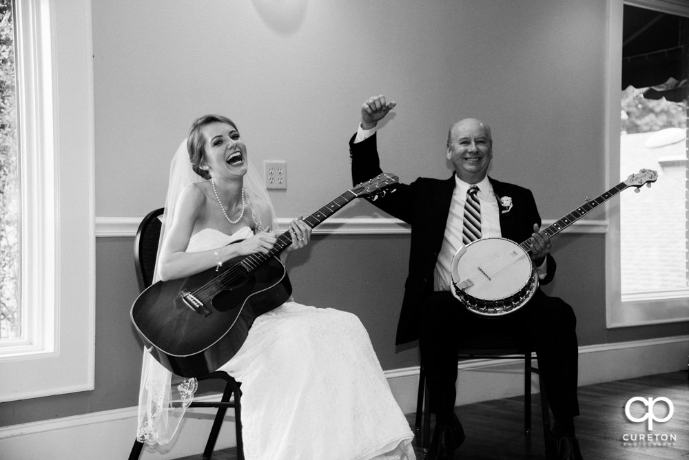 Bride and her father playing guitar and banjo at her wedding reception.