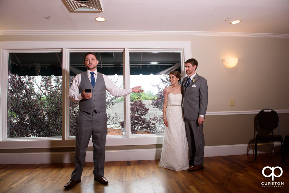 Bride and groom watching as the wedding party gives them a toast.