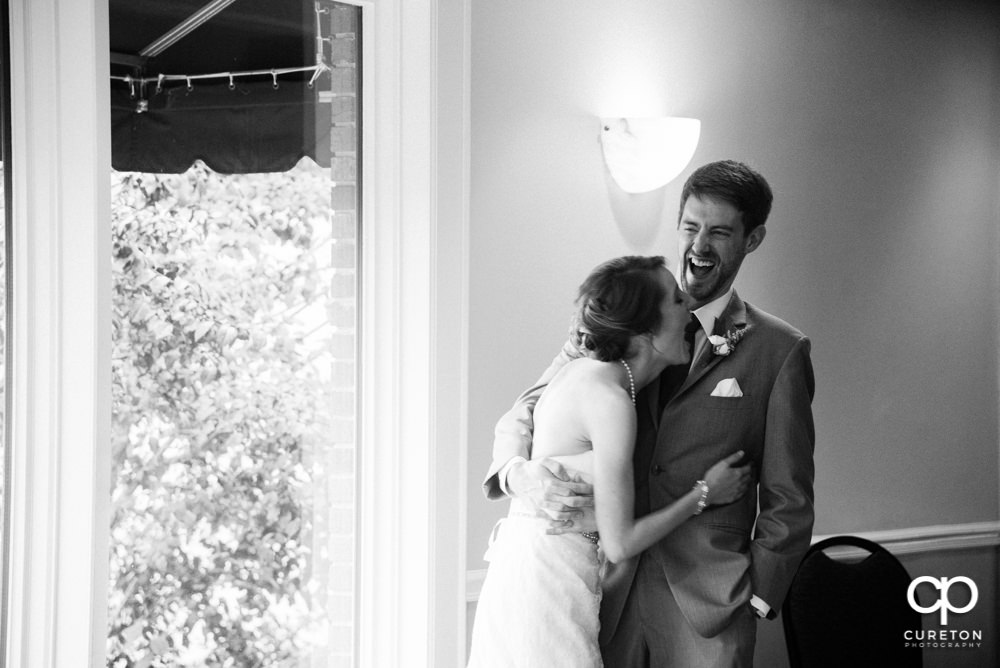 Bride and groom watching as the wedding party gives them a toast.
