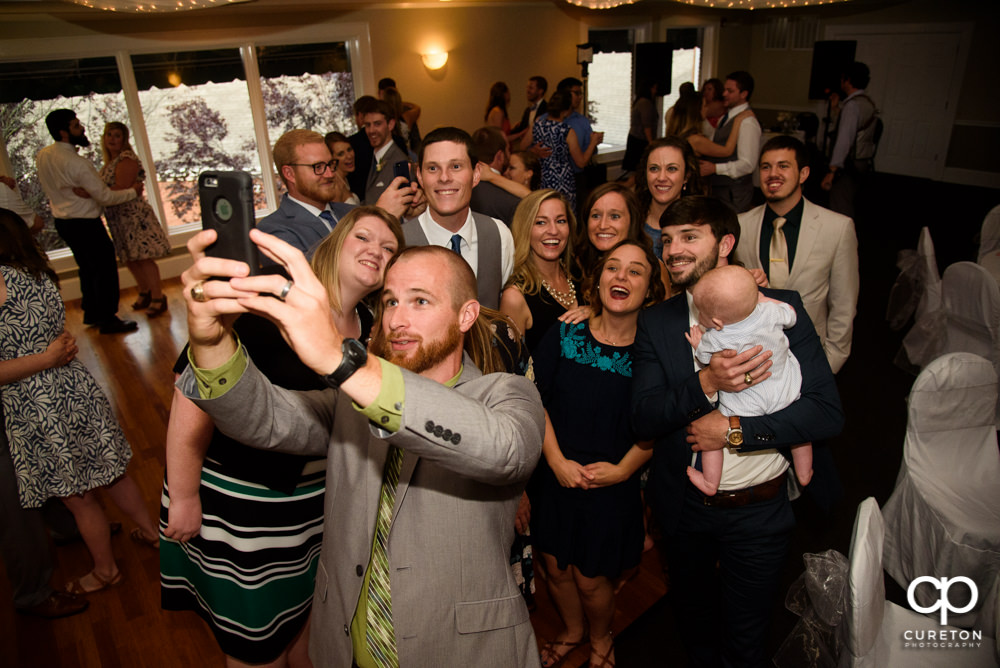Guests taking a selfie at the wedding reception.