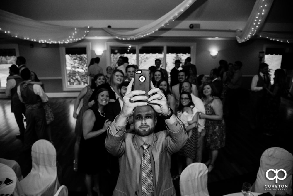 Guests taking a selfie at the wedding reception.