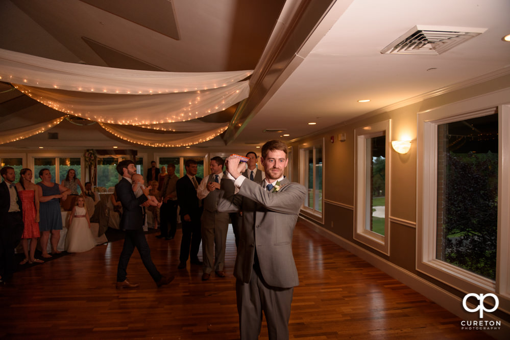 Groom tossing the garter.