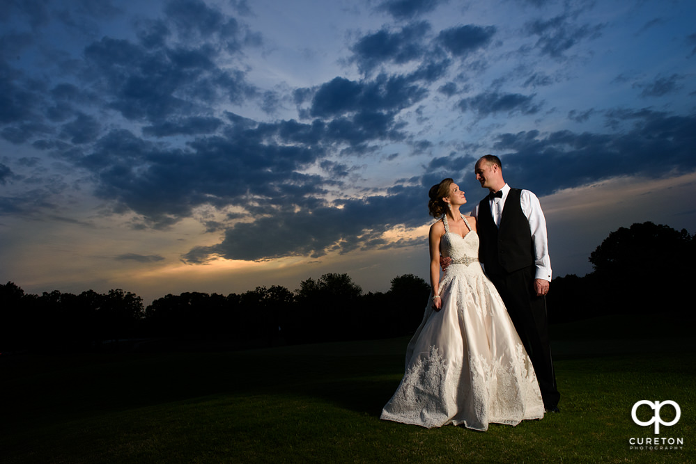 Bride and Groom at sunset on the golf course after their Holly Tree Country Club wedding