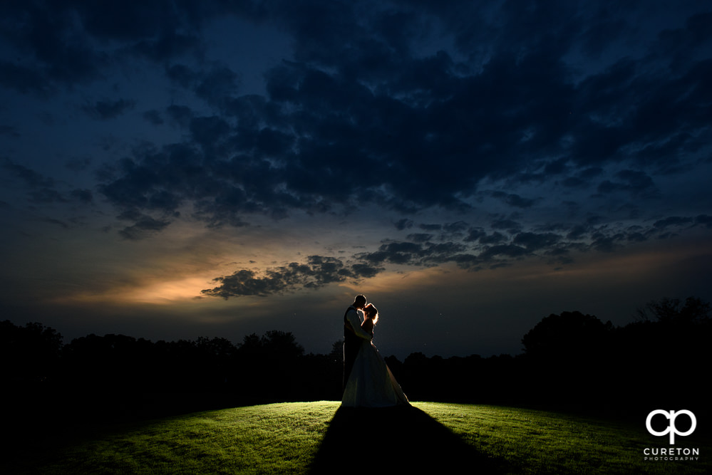 Bride and Groom at sunset on the course after their Holly Tree Country Club wedding reception.