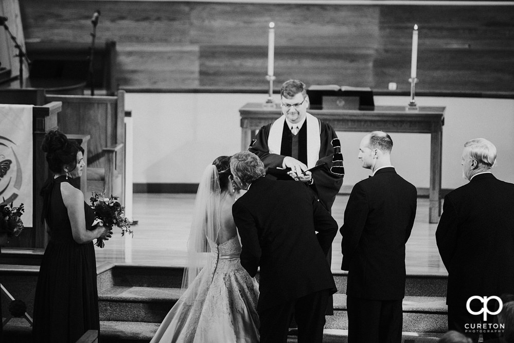 Bride and her father walking down the aisle at the wedding ceremony at Mauldin United Methodist.