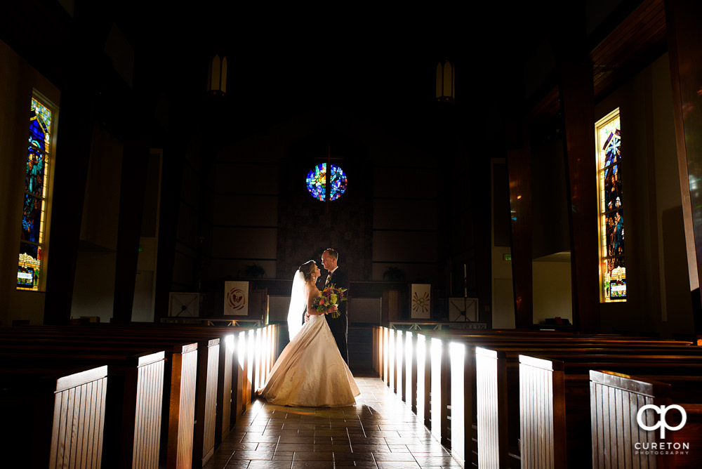 Bride and groom in the sanctuary at Mauldin United Methodist after their wedding.