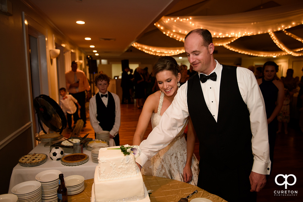 Bride and groom cutting the cake.
