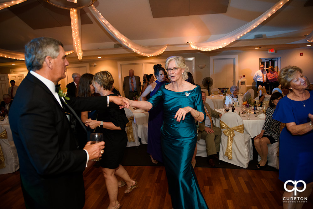 Wedding guests dancing at a Holly Tree Country Club wedding reception while Uptown Entertainment dj's.