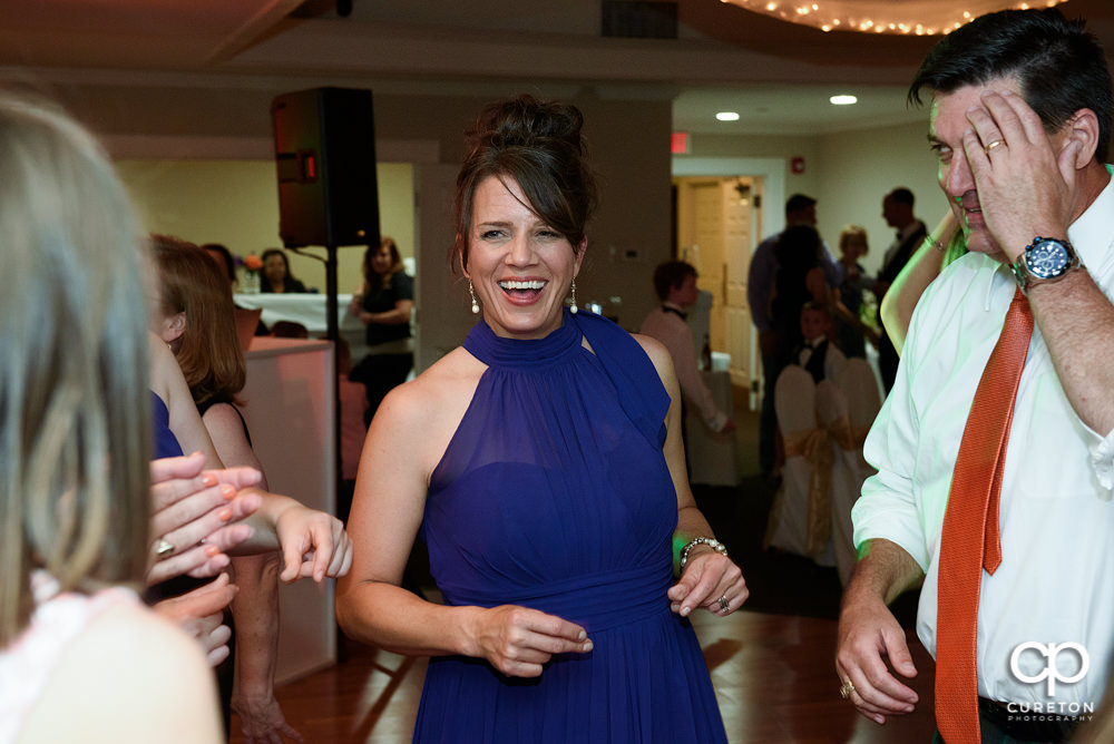 Wedding guests dancing at a Holly Tree Country Club wedding reception .