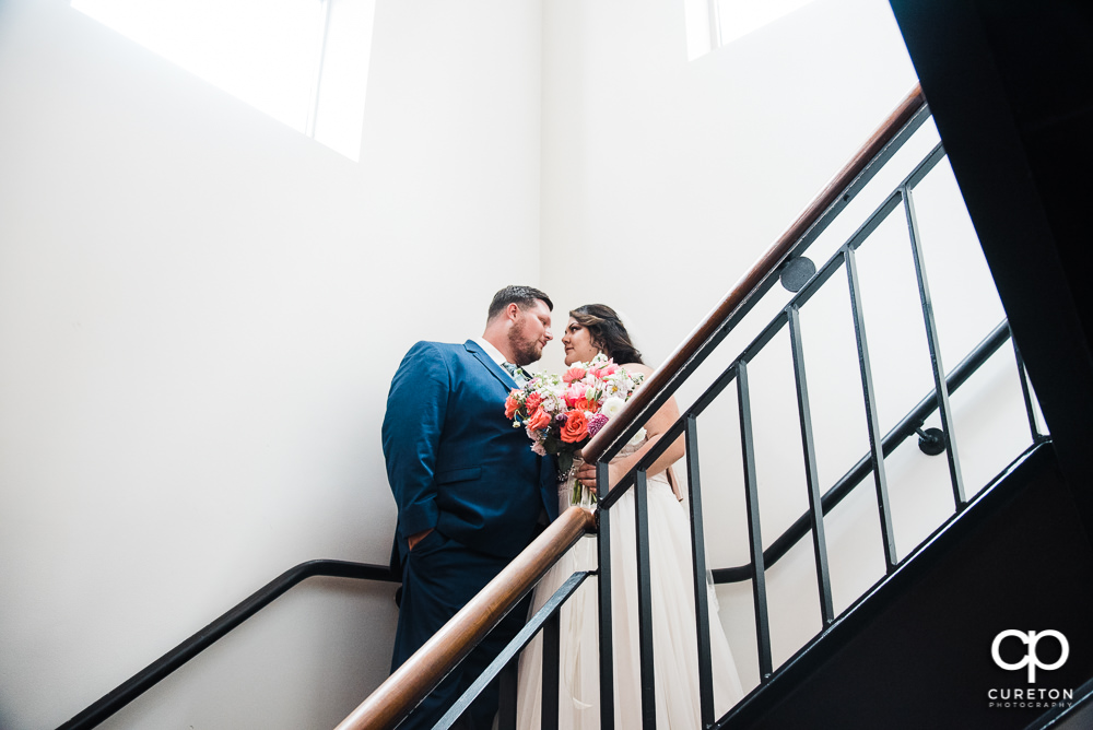 Bride and Groom on the stairs after their Huguenot Loft wedding in Greenville,SC.