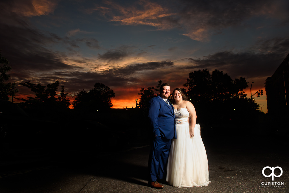 Bride and groom at sunset in downtown Greenville.