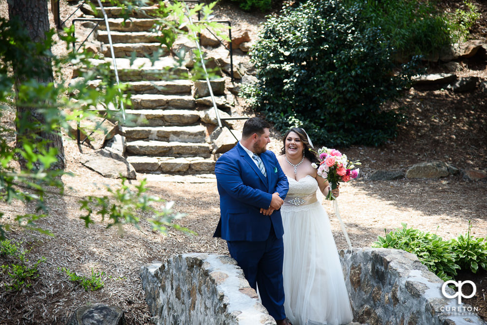 Bride and groom having a first look in the Rock Quarry Garden before their wedding in downtown Greenville.