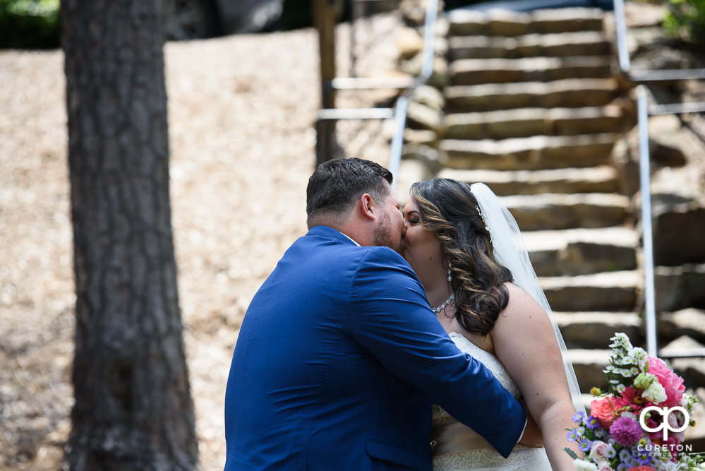 Bride and groom having a first look in the Rock Quarry Garden before their wedding in downtown Greenville.