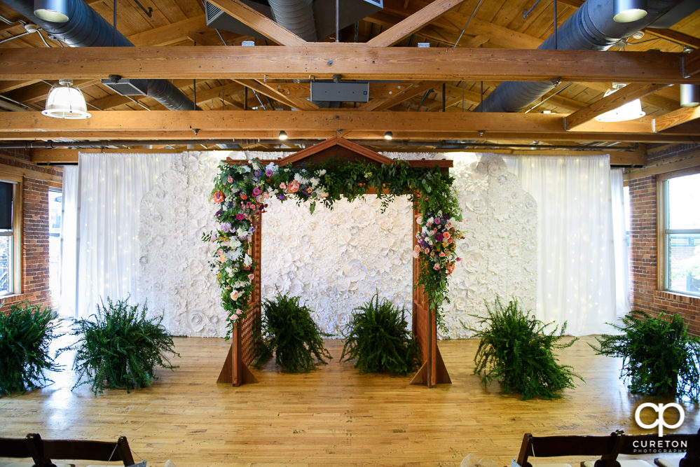 Floral decorated arbor for the ceremony at Huguenot Loft.