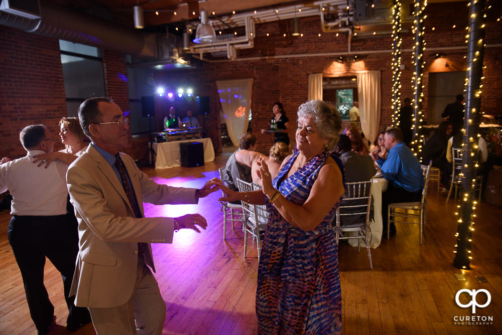 Guests dancing at the Huguenot Loft wedding reception in Greenville SC.