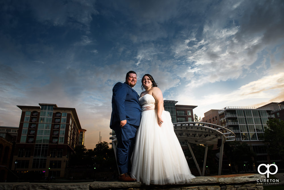 Bride and groom at sunset with an epic sky backdrop in downtown Greenville SC.