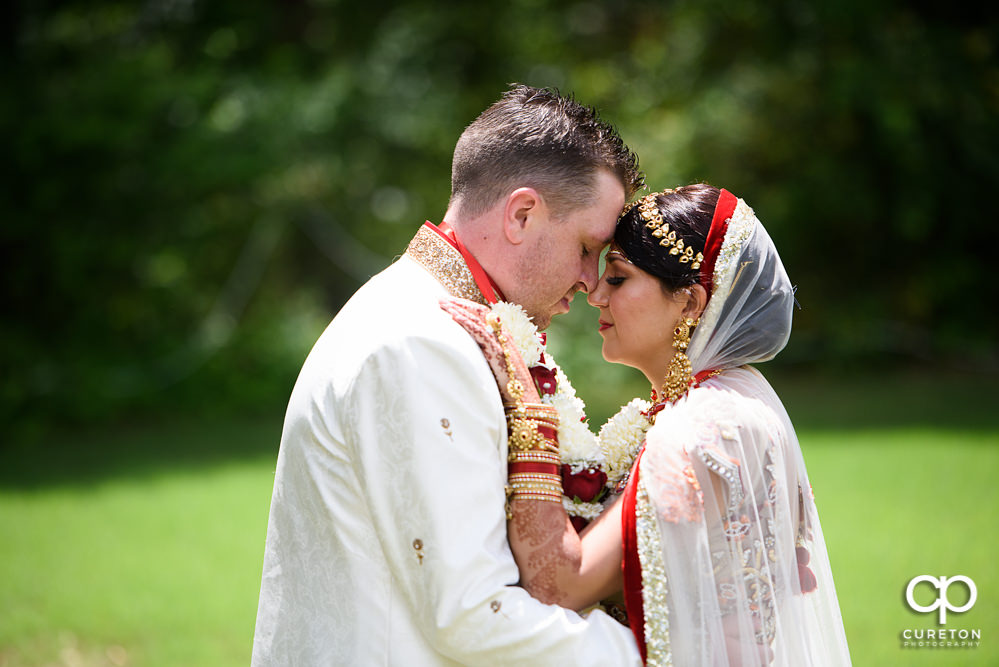 Bride and groom snuggling after their Indian wedding at Embassy Suites in Greenville,SC.