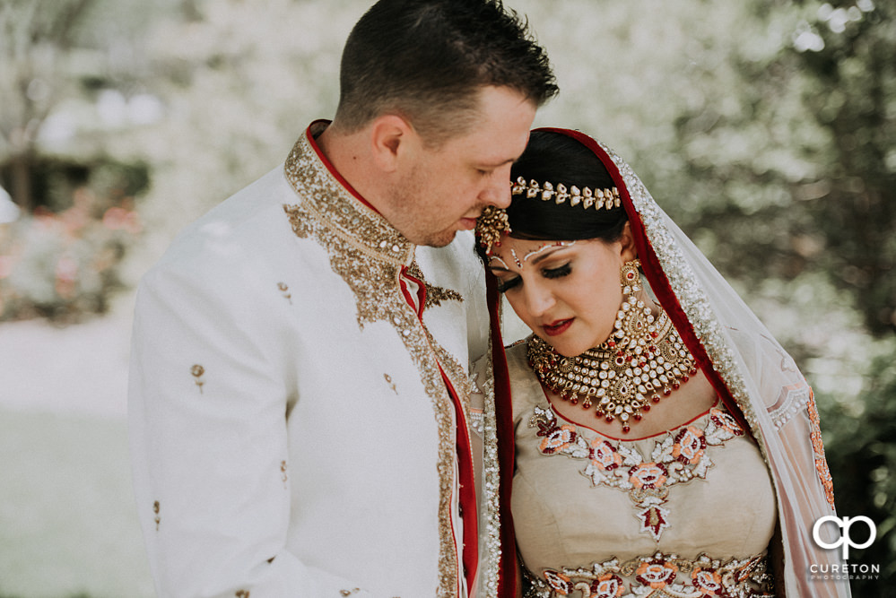 Bride leaning on her groom after their Indian wedding at Embassy Suites in Greenville,SC.