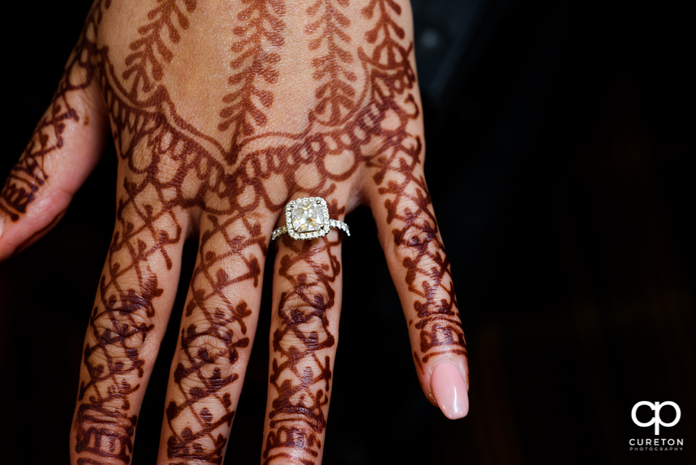 Wedding ring on a henna covered hand.