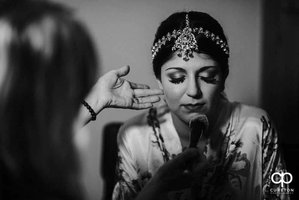 Indian bride getting makeup done by Cotton Rouge and Co.