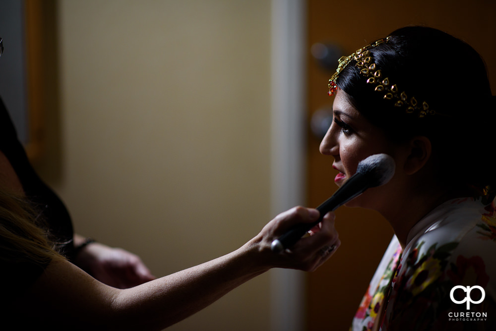 Indian bride getting makeup by Cotton Rouge.