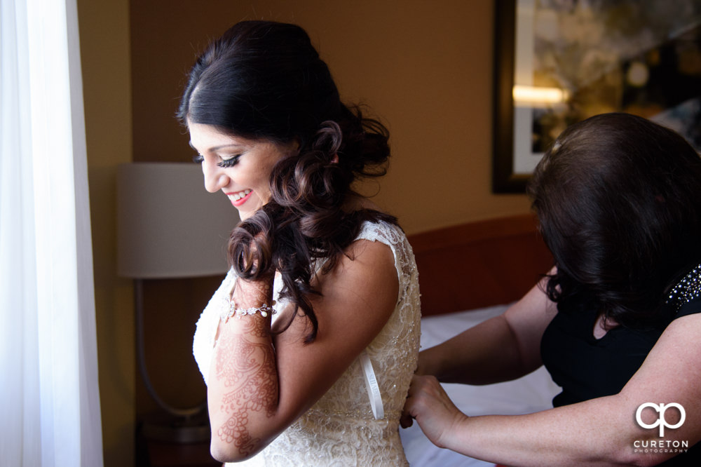 Indian bride getting ready for the second American wedding ceremony of the day.