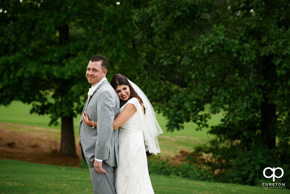 Bride and groom on the golf course at Embassy Suites.