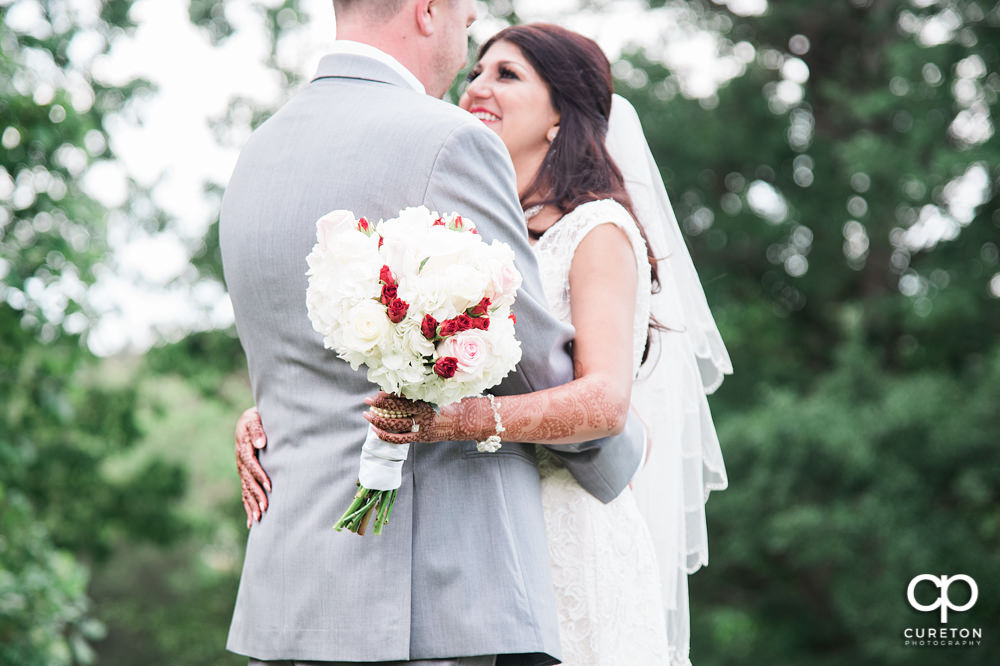 Bride and groom on the golf course at Embassy Suites.