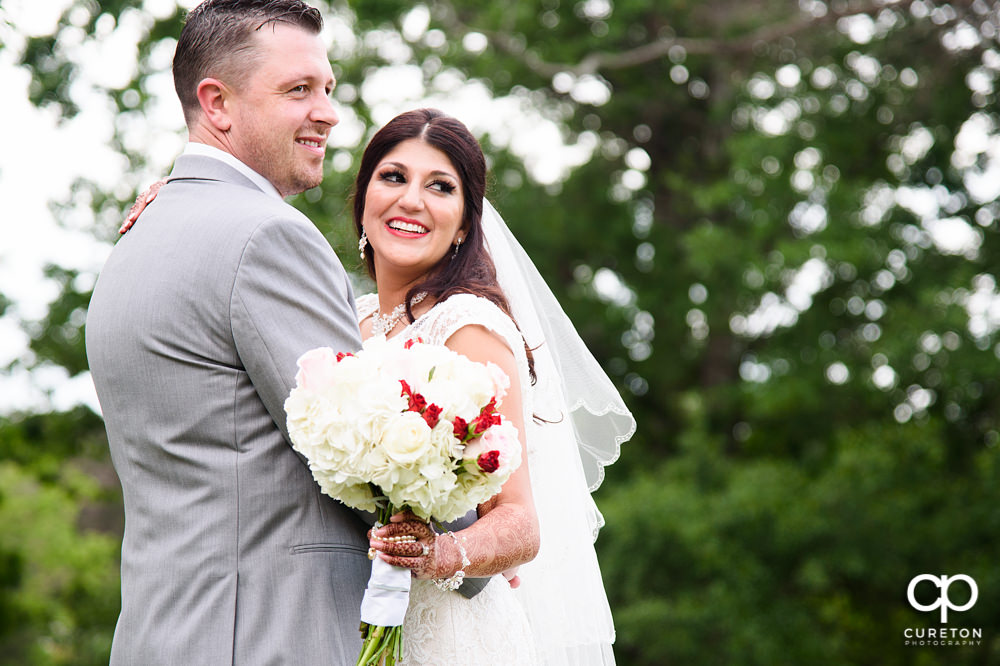 Bride and groom on the golf course at Embassy Suites.