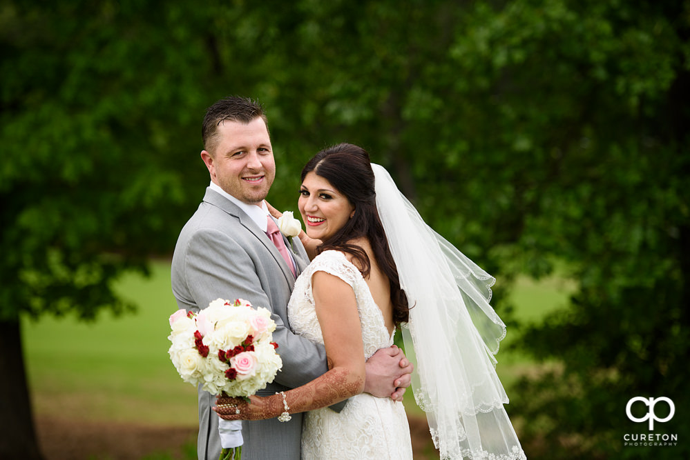 Bride and groom on the golf course at Embassy Suites.