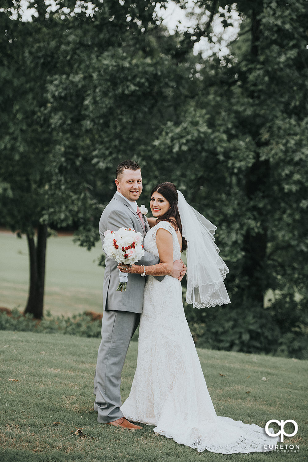 Bride and groom on the golf course at Embassy Suites.