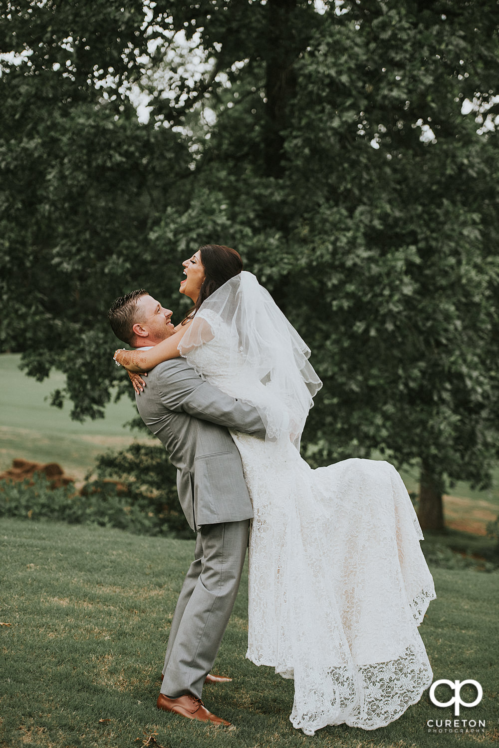 Bride and groom on the golf course at Embassy Suites.