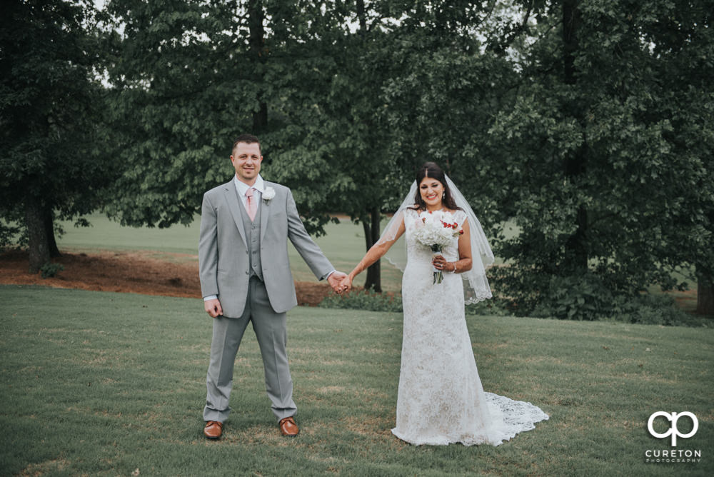 Bride and groom on the golf course at Embassy Suites.