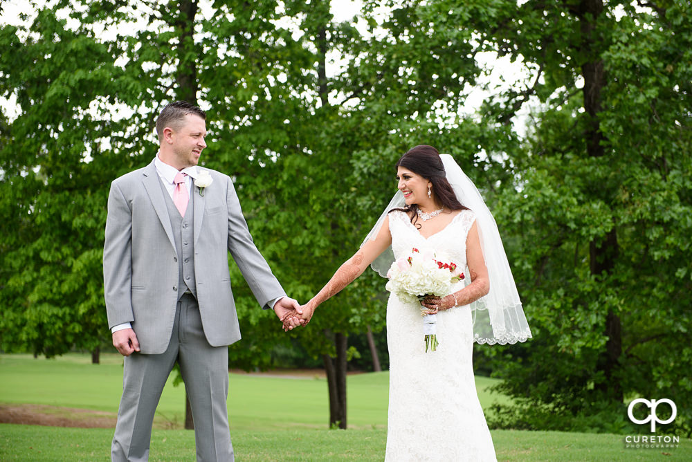 Bride and groom on the golf course at Embassy Suites.