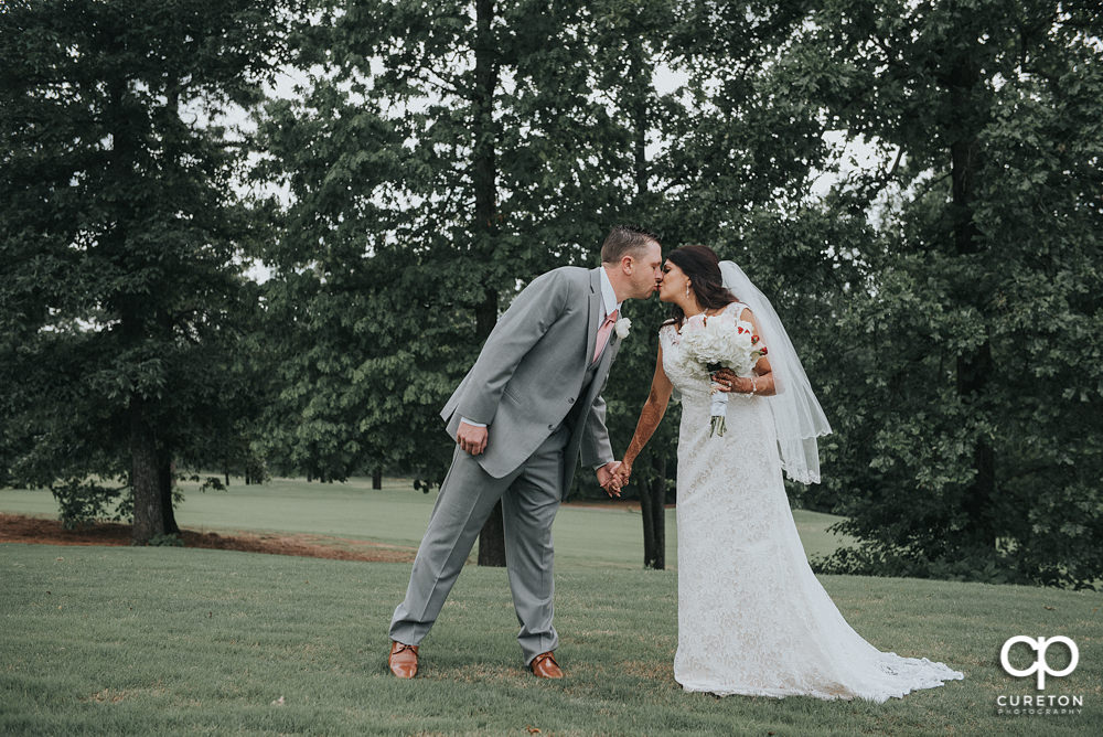 Bride and groom on the golf course at Embassy Suites.